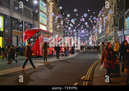 London, UK - November, 2018. Oxford Street in central London decorated with Christmas lights and crowded with people on a shopping spree. Stock Photo