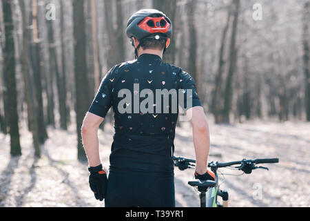 male athlete mountainbiker rides with bicycle in the forest Stock Photo