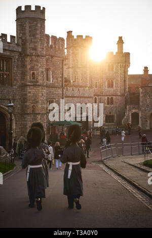 Windsor, UK - December, 2018. A group of sentry grenadier guards in theirs iconic uniform marching outside Windsor Castle Gate. Stock Photo