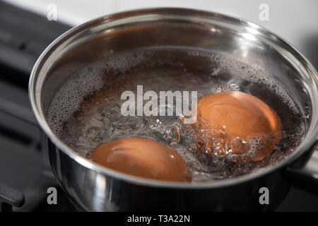 Boiling eggs in a saucepan Stock Photo