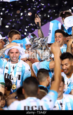 Buenos Aires, Argentina - April 07, 2019: Lisandro Lopez (Racing) rising the Superliga Cup 2019 and kissing it with his teammates in the Juan Domingo  Stock Photo