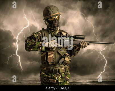 Armed soldier standing in rainy obscure weather  Stock Photo