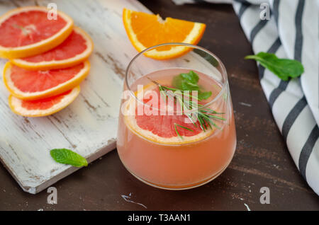 Ripe grapefruit and oranges with grapefruit juice on wooden table, Stock Photo
