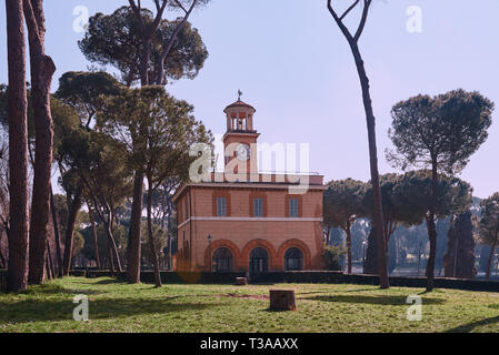 Rome, Italy, 19 February 2019, Villa Borghese, view through the park plants on Casino dell'Orologio, formerly was house of the gardener. Around 1791 w Stock Photo