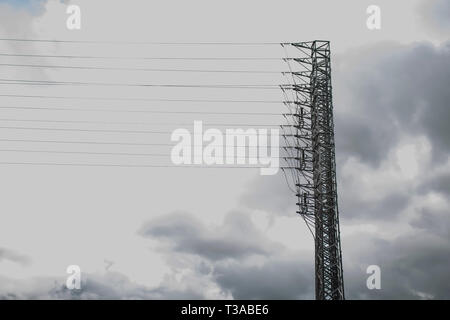 Power pole on the background of thunderclouds. Tragic sight Stock Photo