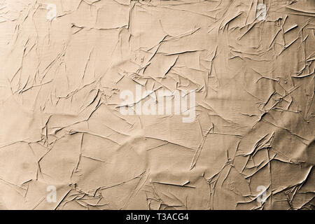 Crumpled creased posters grunge paper textures. Blank old ripped torn street billboard posters background. Stock Photo