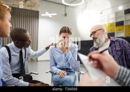 Young Woman Crying in Support Group Stock Photo