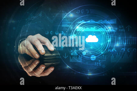 Hand using wireless mouse with cloud technology concept and dark background Stock Photo