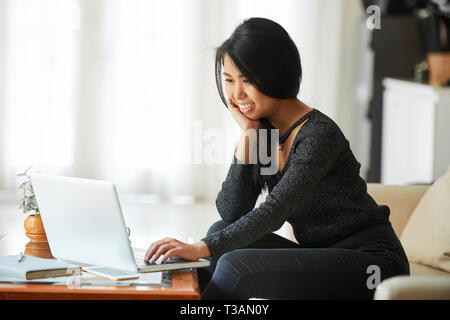 Young woman working on laptop Stock Photo