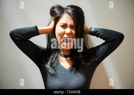 Screaming young Vietnamese woman Stock Photo