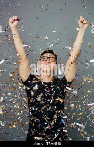 Man standing in falling confetti Stock Photo