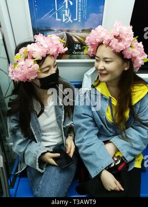 Beijing, China. 3rd Apr, 2019. Girls chat in a subway carriage in Beijing, capital of China, April 3, 2019. Credit: Wang Siwei/Xinhua/Alamy Live News Stock Photo