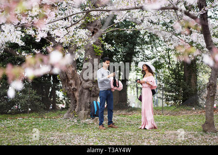 Washington, DC, USA. 7th Apr, 2019. Visitors prepare to take photos at the Tidal Basin in Washington, DC, the United States, April 7, 2019. This year's blossoms reached peak bloom in the first week of April. Credit: Han Fang/Xinhua/Alamy Live News Stock Photo