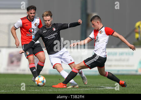 ROTTERDAM - 08-04-2019  , Sportpark Varkenoord , Dutch Reservecompetitie poule A , season 2018-2019 , (R-L) Jong Feyenoord player Jeremy van Mullem , Jong Emmen player Robbert de Vos , Jong Feyenoord player Orkun Kokcu during the match Jong Feyenoord - Jong Emmen Stock Photo