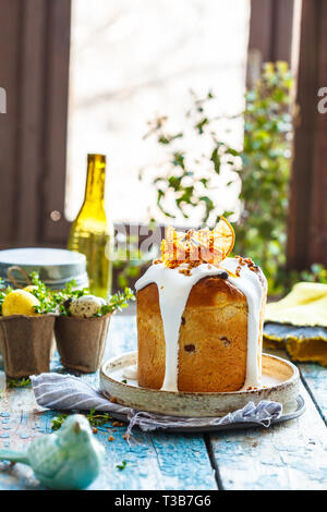 Easter cake with icing on a blue wooden table. Easter concept. Stock Photo