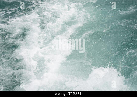 Close up Bubble wave Turquoise color from the bottom of the ship rowing in the ocean, for Background. Stock Photo