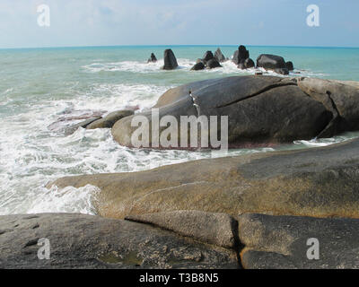 Huge stones on the beach. Boulders on the coast. On the sand are big stones. Stock Photo