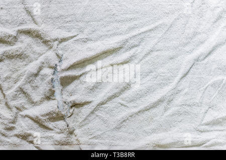 teared rag spread out to flat on the floor, can use like a background or any texture. Stock Photo