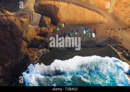 Fishing boats in bay near El Golfo, drone shot, Lanzarote, Canary Islands, Spain Stock Photo