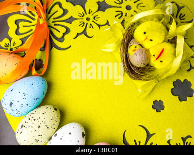 easter composition, colorful eggs, nest of chickens, greeting card, copy space Stock Photo
