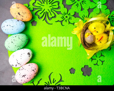 easter composition, colorful eggs, nest of chickens, greeting card, copy space Stock Photo