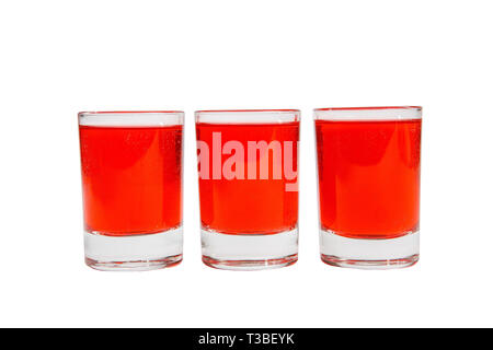 Monochrome transparent cocktails, a set of shots in one row, three servings, with a taste of berries, cherries, Side view Isolated white background Stock Photo
