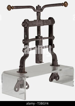 A large French seal press, circa 1700 Heavy frame of forged iron bars bolted together with nuts. Central vertical threaded rod, the handle bar with spherical brass finials. The lower end of the ram fitted with a receiver for signets with retaining screw. At the bottom ends of the frame two stud bolts with large thumb nuts for table top mounting. Mounted on a modern acrylic glass stand. Height 51 cm, width 42 cm. historic, historical, 18th century, handicrafts, handcraft, craft, object, objects, stills, clipping, clippings, cut out, cut-out, cut-o, Additional-Rights-Clearance-Info-Not-Available Stock Photo