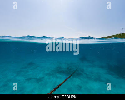 Underwater view of an anchor chain of a ship. Stock Photo