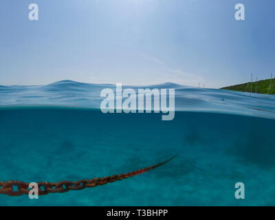 Underwater view of an anchor chain of a ship. Stock Photo