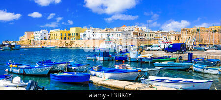 Beautiful Gallipoli old town,view with colorful houses,fortress and boats,Puglia,Italy. Stock Photo