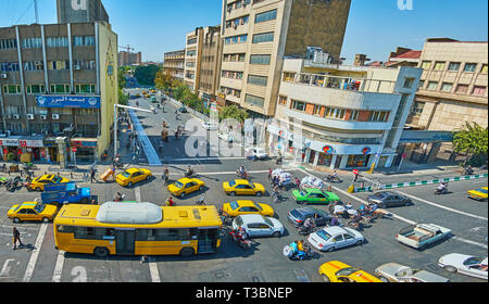 TEHRAN, IRAN - OCTOBER 25, 2017: Numerous yellow and green taxi cars in chaotic traffic along the busy city streets of Amir Kabir and Pamenar, on Octo Stock Photo