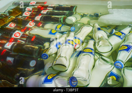 TEHRAN, IRAN - OCTOBER 25, 2017: The small glass bottles with Zamzam cola drink and doogh yogurt-based drink in refrigerator, filled with ice and cold Stock Photo