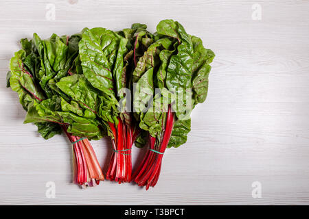 Beet tops are rich with antioxidants, high minerals, vitamins and low in fat and cholesterol. Health benefiting concept. Top view with copy space. Sel Stock Photo