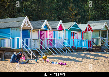 Colourful beach huts on Wells beach at Wells next the Sea on North Norfolk coast, East Anglia, England, UK. Stock Photo