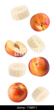Flying slice banana and peach fruits isolated on white background with clipping path as package design element and advertising. Stock Photo
