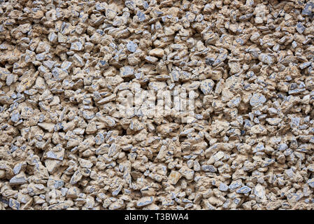 Background texture of the wall with small stones close-up. Stock Photo