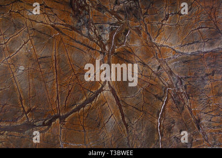 The background of the natural stone is orange marble with interesting dark veins called Bidasar Brown. Stock Photo