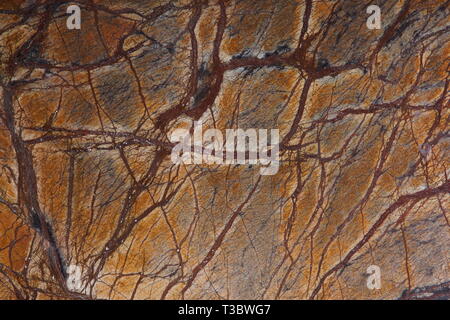 Natural stone orange marble with interesting dark streaks is called Bidasar Brown. Stock Photo