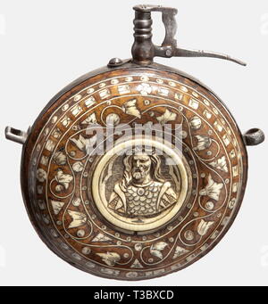A large German bone-inlaid powder flask, circa 1600. Round root wood body richly inlaid with engraved bone. Carved medallions set into both sides (Historism period additions?). Surrounding iron band with two suspension rings. Iron nozzle with broken spring. Height 16.5 cm. Diameter 13.5 cm. historic, historical, 17th century, powder flask, accessory, accessories, military, militaria, object, objects, stills, utilities, utility, clipping, clippings, cut out, cut-out, cut-outs, utensil, piece of equipment, utensils, Additional-Rights-Clearance-Info-Not-Available Stock Photo