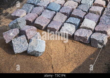 cobblestone paving - granite stone pavers on the gravel Stock Photo