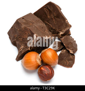 Dark or milk organic chocolate pieces ant hazelnuts isolated on white background Stock Photo