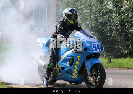 Chorley, Lancashire, UK. 7th April, 2019. Hoghton Tower 43rd Motorcycle Sprint. Rider 54 Daniel Tomlinson from Blackkburn riding blue Suzuki CBR 600 RR.  Motorcycle wheel burning tires and smoking on race track, sport motorcycle burnout, tank slapping with lots of smoke and rubber. Stock Photo