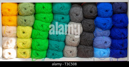 Colorful yarns for sewing on the shelf.  Skeins of yarn concept. Stock Photo