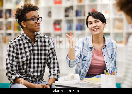 Creative students discussing ideas in library Stock Photo