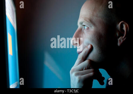 man working on computer late at night Stock Photo