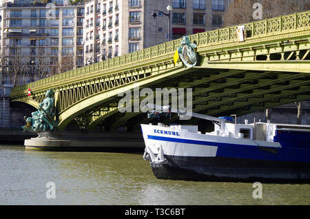 The Pont Mirabeau over the river Seine, linking the 15th & 16th arrs.  Formed of two sets of steel cantilevers painted in a yellowish green. Stock Photo