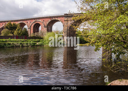 A scenic view of the River Tees at Yarm  showing the rail viaduct and tree lined river banks Stock Photo