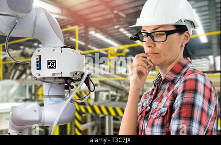 Virtual Augmented reality technology in industry 4.0. Engineer woman wearing AR glasses to see AR service,Thermal Monitoring motor for check destroy p Stock Photo