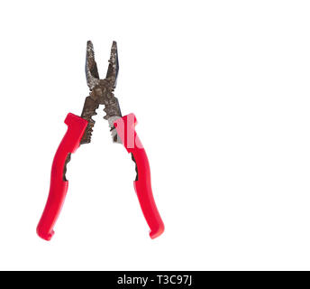 old rusty pliers with isolated red handles isolated on white background close-up Stock Photo