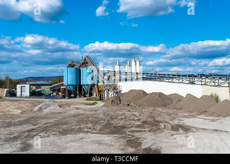 Heaps of gravel and crushed on blue sky at an industrial cement plant. Stock Photo